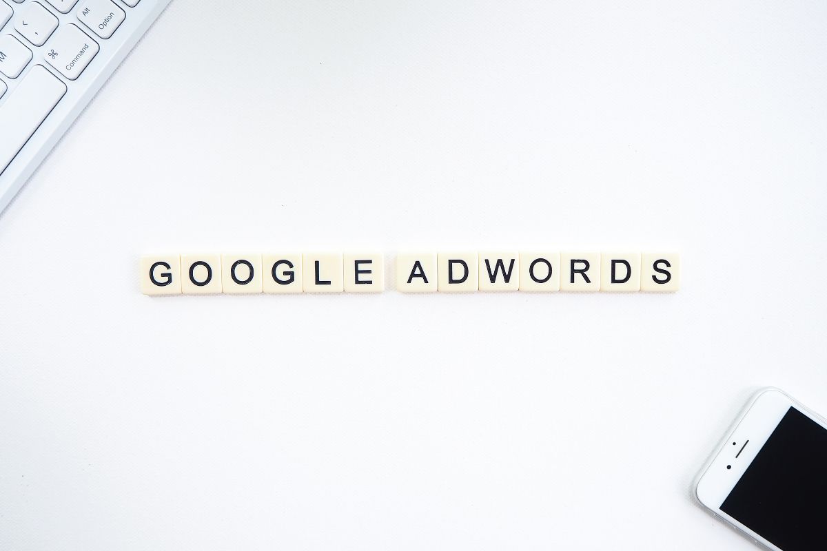 Google Adwords spelled out in Scrabble letter tiles, representing paid advertising as a complement to organic SEO