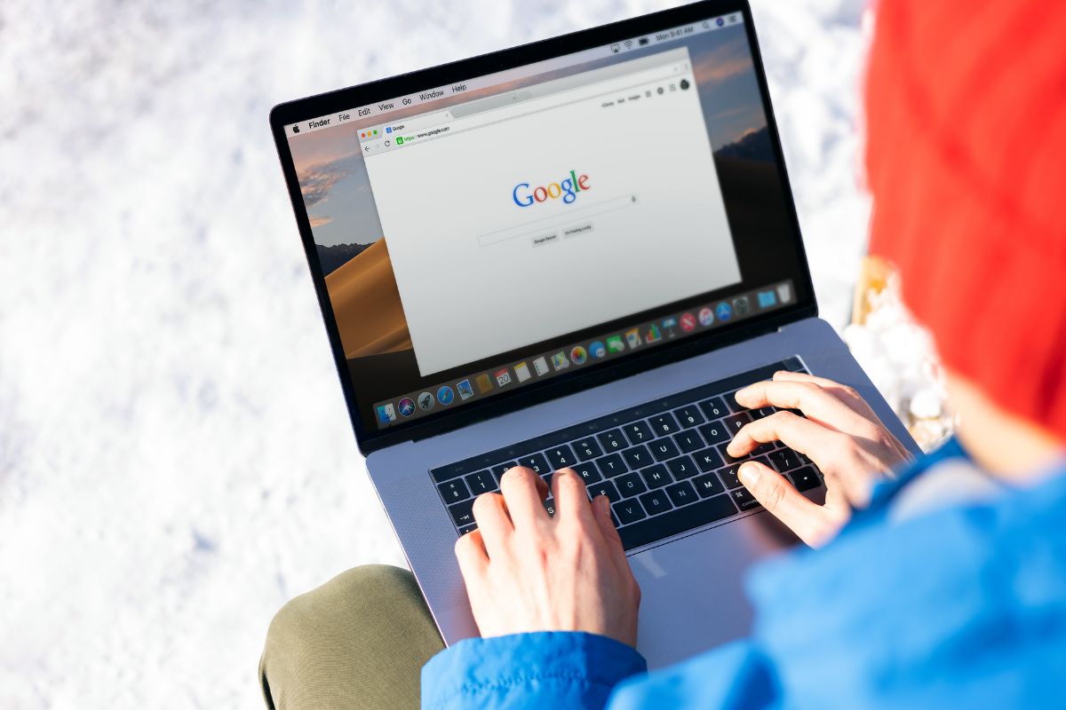 Person searching on a laptop outdoors, representing how customers try to find local Cornwall businesses on Google