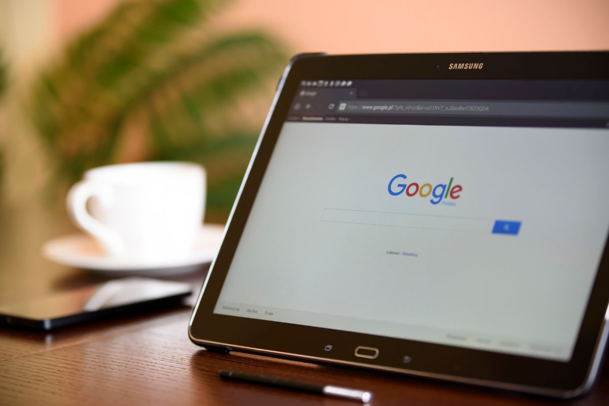 Person searching Google on a tablet, showing how potential customers find businesses