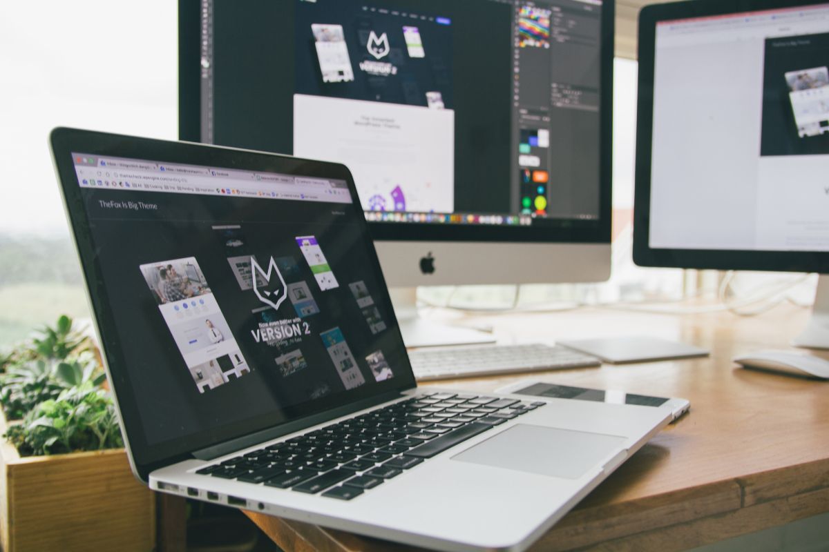 Web designer working on a client website using a professional dual screen setup